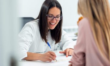 Beautiful young nutritionist woman explaining to her patient the