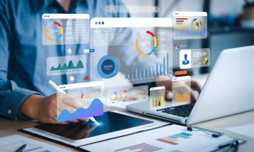 An analyst uses a computer and dashboard for data business analy
