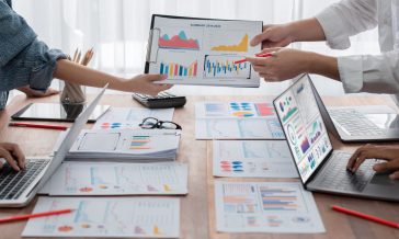 Analyst team utilizing BI Fintech to analyze financial report. Scrutinize