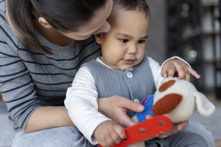 adorable-baby-playing-with-his-mother-with-toy