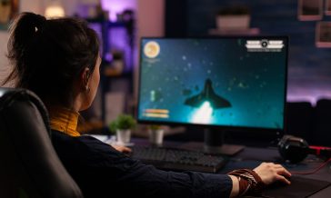Adult using keyboard and mousepad to play video games
