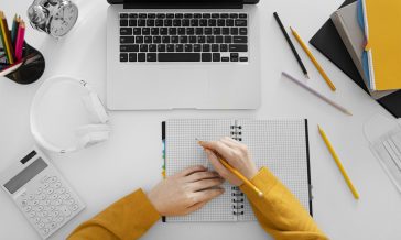cerrar-mano-escribiendo-vista-superior-cuaderno