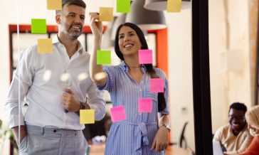 Team of Caucasian businessman and businesswomen working together in their office